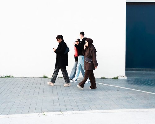 Group of friends walking enthusiastically in a modern city street